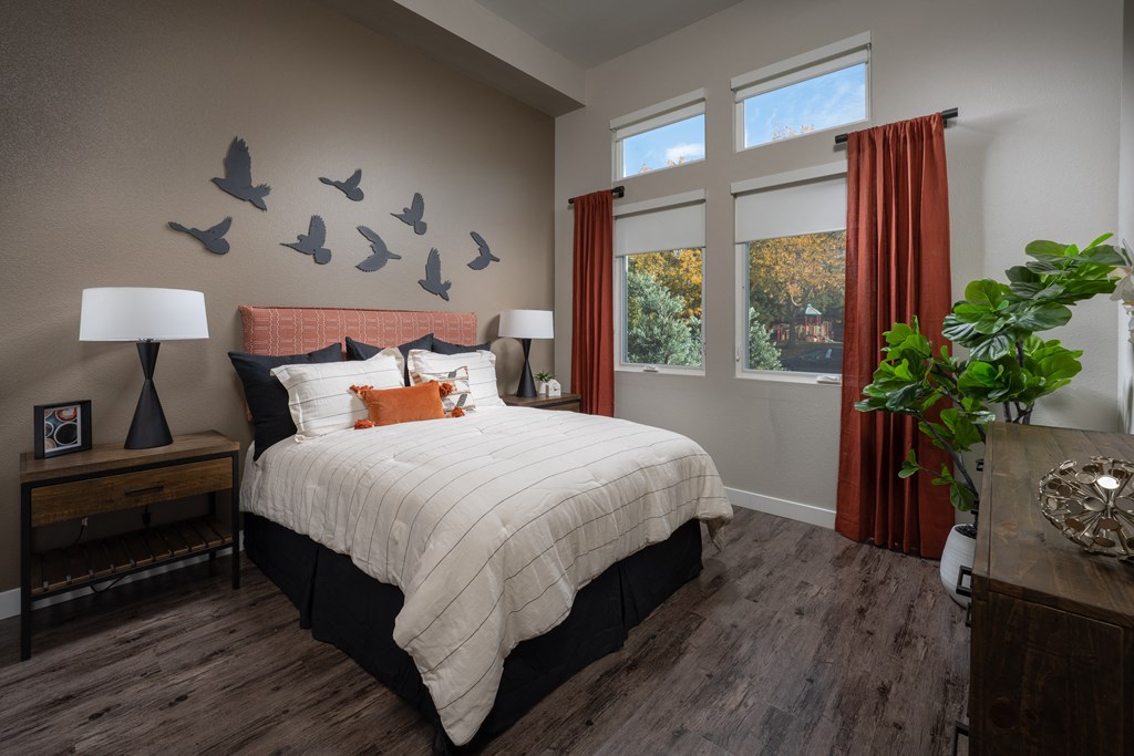 a bedroom with a bed and birds on the wall