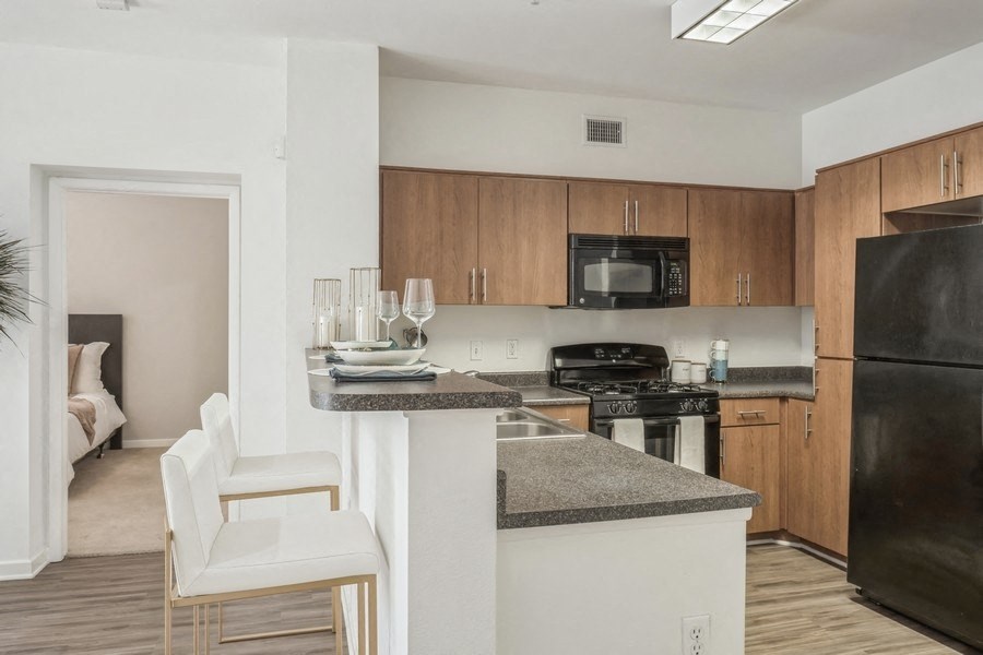 a kitchen with an island and a stove and a refrigerator