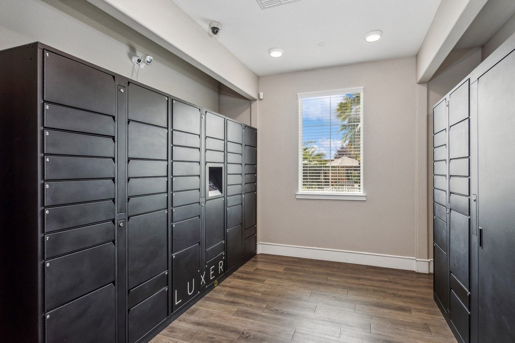 a row of black lockers in a room with a window