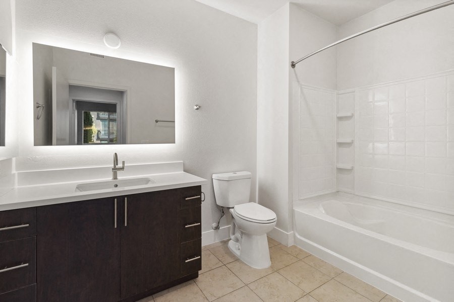 a bathroom with a toilet and a sink and a bath tub