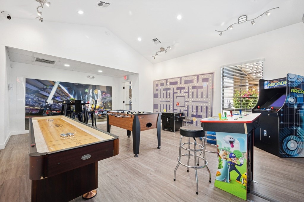 Resident social lounge with a shuffleboard table and a pool table.