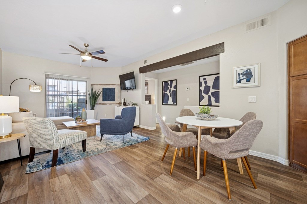 A living room with a white table and chairs.