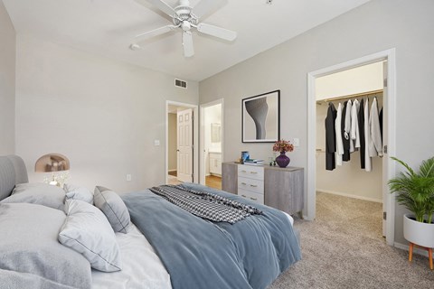 a bedroom with a bed and a ceiling fan