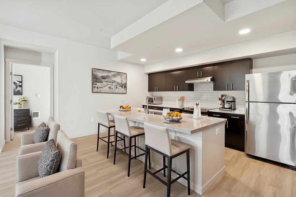 A modern kitchen with a dining table and chairs.