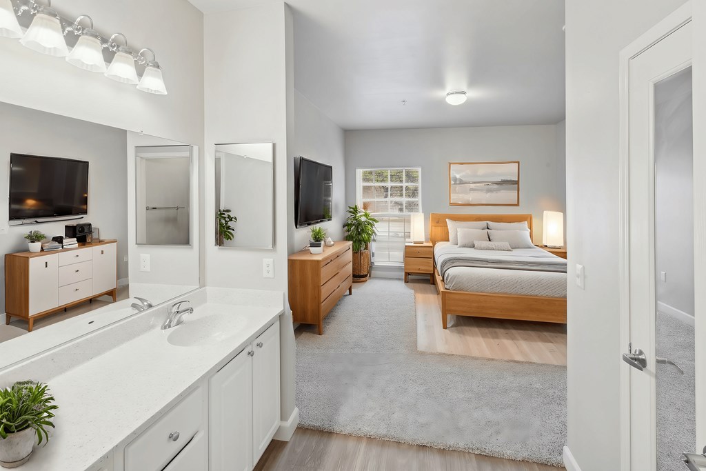 A bedroom with a bed, dresser, and mirror.