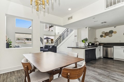 a dining room and kitchen with a table and chairs