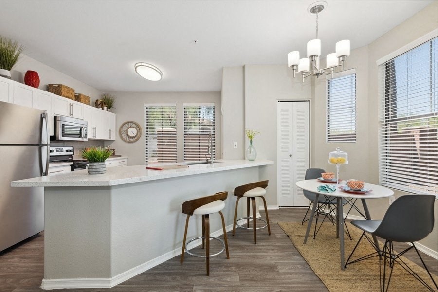 a kitchen with a breakfast bar and a small dining table