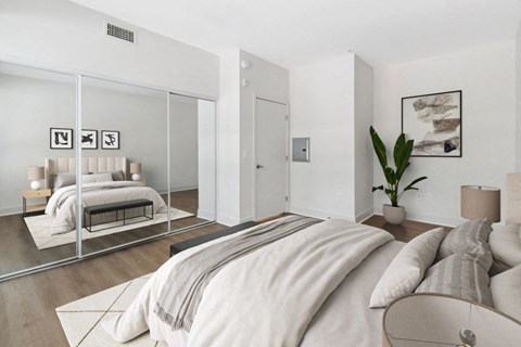 a bedroom with a large bed and a mirror