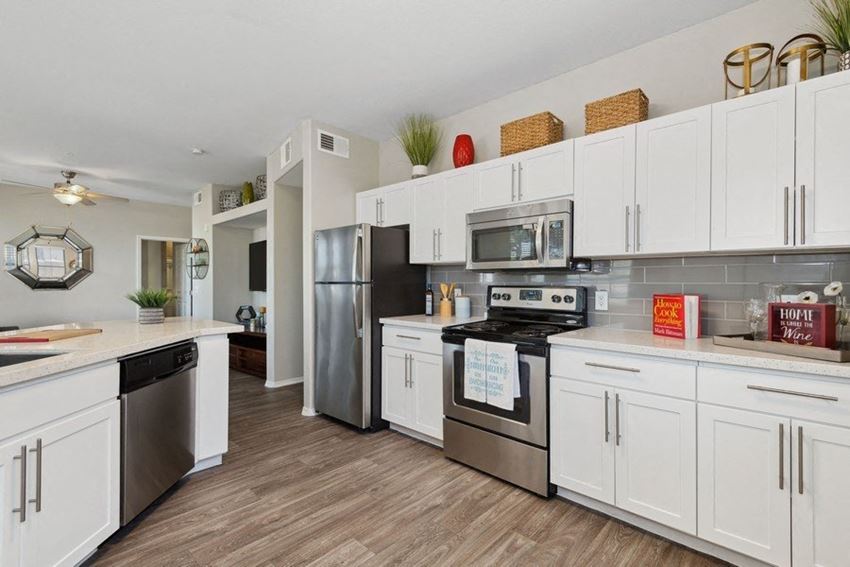a kitchen with white cabinets and stainless steel appliances - Photo Gallery