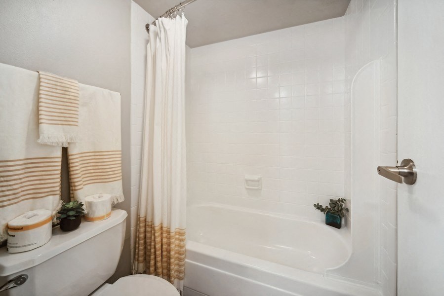 a bathroom with a tub and a sink and a toilet
