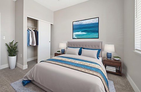 A bedroom with a large bed and a painting of a beach scene on the wall.
