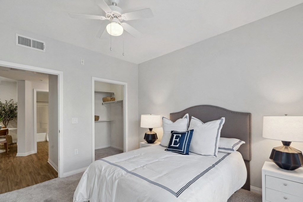 a bedroom with a large bed and a ceiling fan