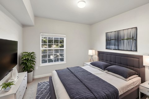 A bedroom with a large bed and a television.