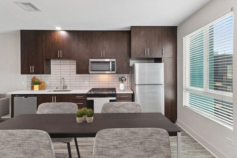 A modern kitchen with a table and chairs.