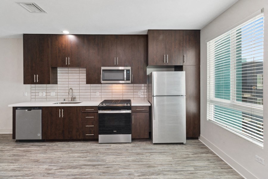 a kitchen with stainless steel appliances and a window