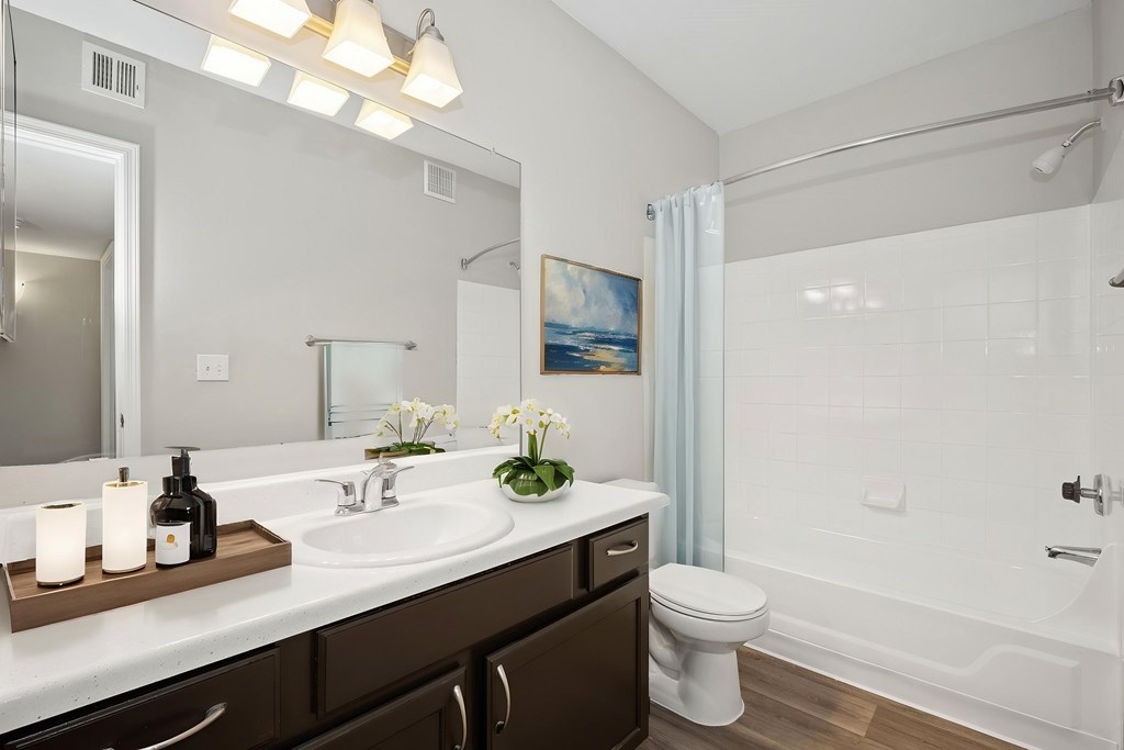 A bathroom with a white sink and a white toilet.