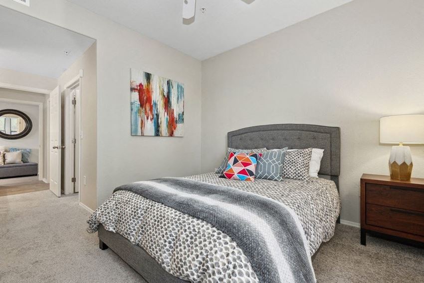 a bedroom with a bed and two night stands - Photo Gallery