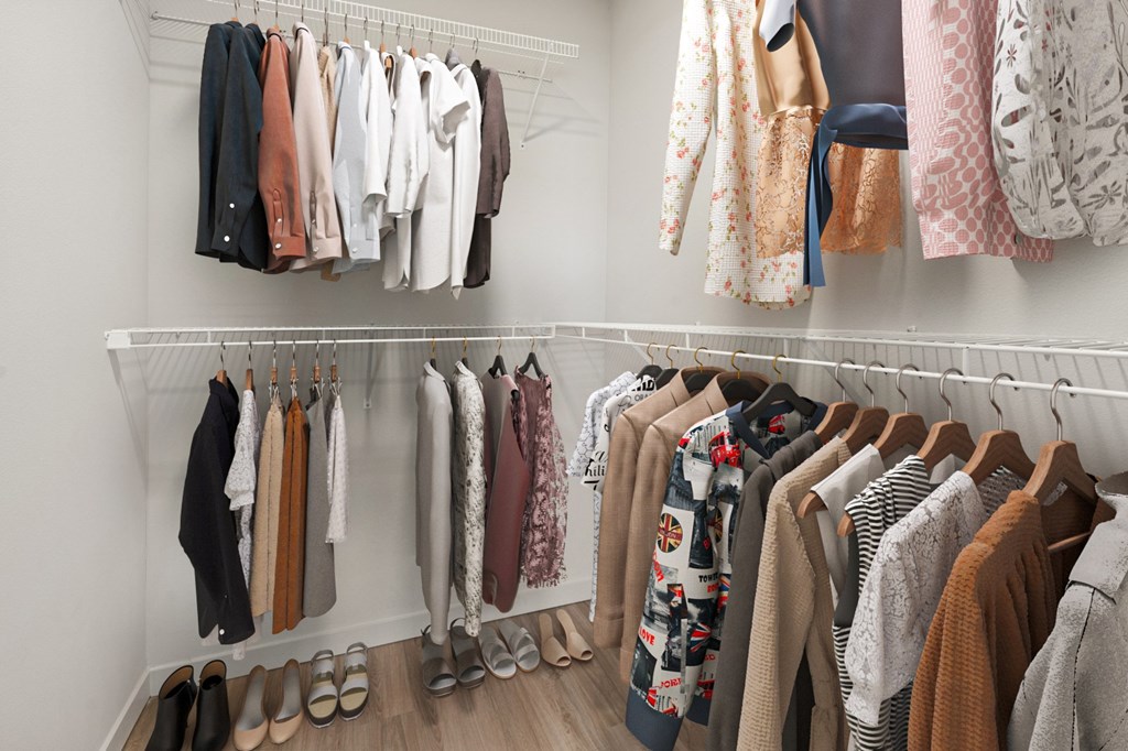Clothes hanging on a rack in a room.
