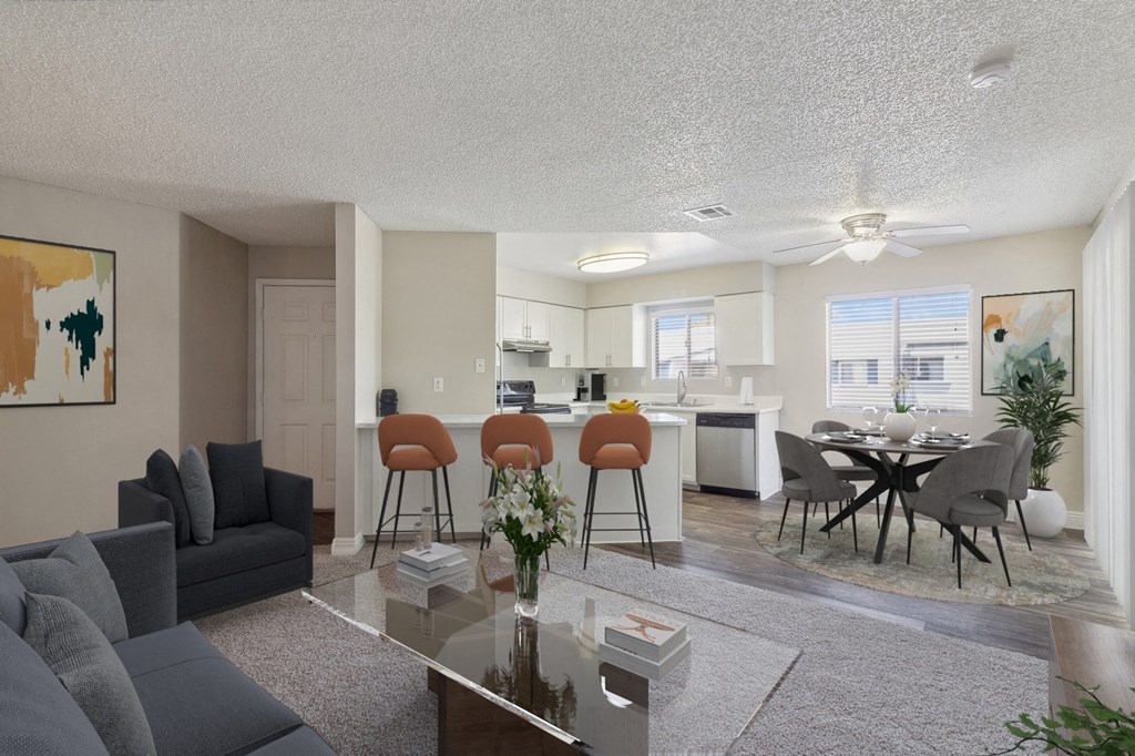 an open living room and kitchen with a table and chairs