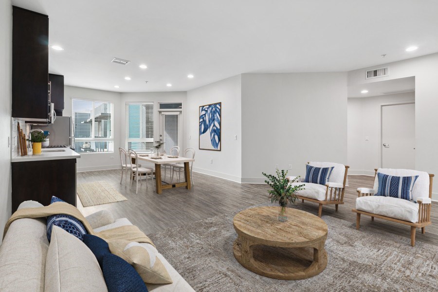 A living room with a white couch and a coffee table.