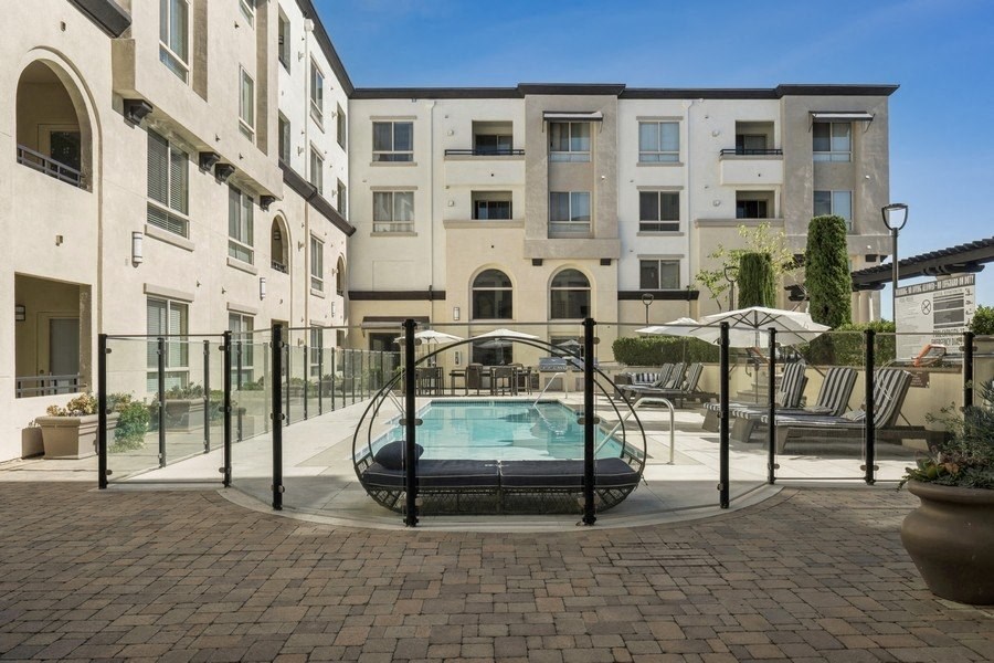 a swimming pool in front of an apartment building