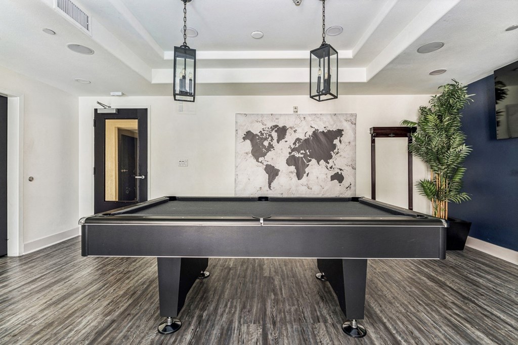 a game room with a pool table and a tv
