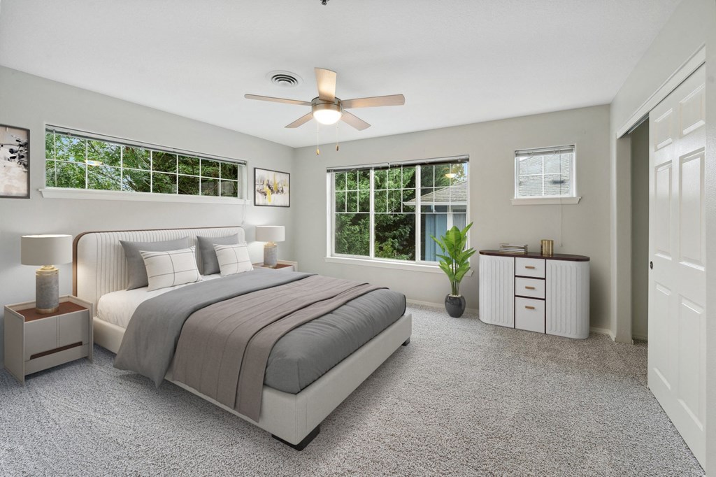 a bedroom with a bed and a ceiling fan