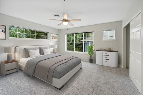 a bedroom with a bed and a ceiling fan