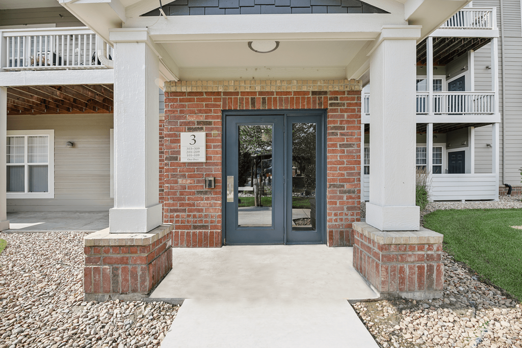 A house with a black door and a number 3 on the wall.
