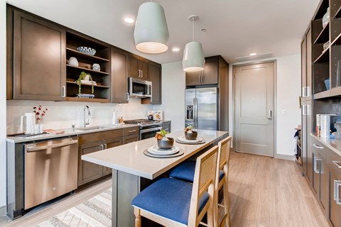 a kitchen with stainless steel appliances and a white counter top
