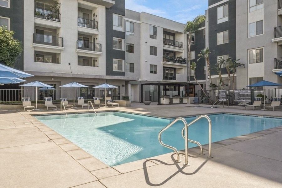 a swimming pool in front of an apartment building
