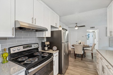a kitchen with stainless steel appliances and white cabinets