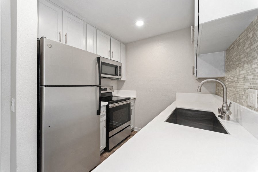 modern kitchen with stainless steel appliances at Pointe Luxe Apartment Homes, San Diego, CA, 92110