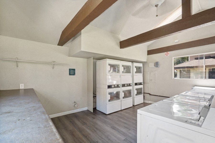 a kitchen with white appliances and a large window
