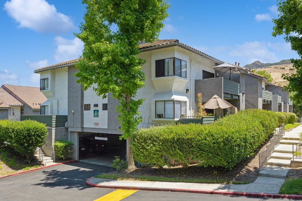 the view of an apartment building from the street
