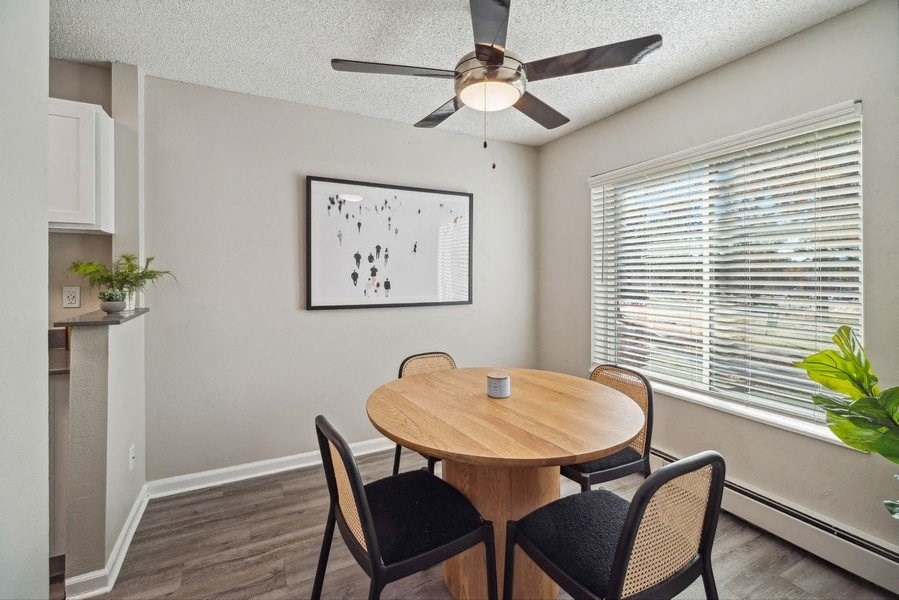 a dining room with a table and a ceiling fan