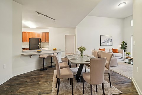 A modern dining room with a table set for four.