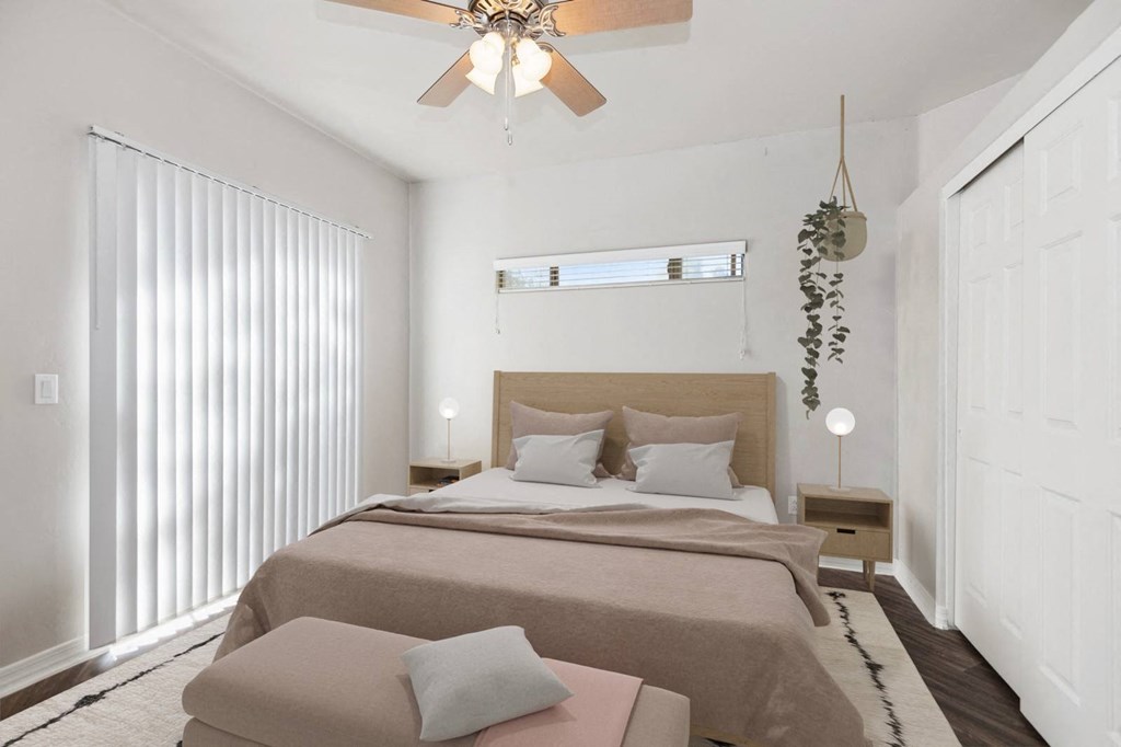 a bedroom with a large bed and a ceiling fan