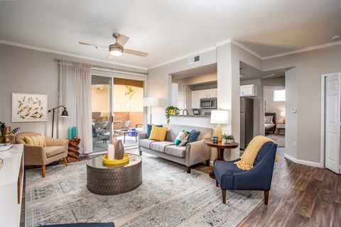 a living room with furniture and a ceiling fan