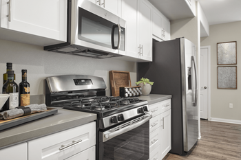 Kitchen With White Cabinetry And Appliances at Mitchell Place Apartments, Murrieta, CA, 92562