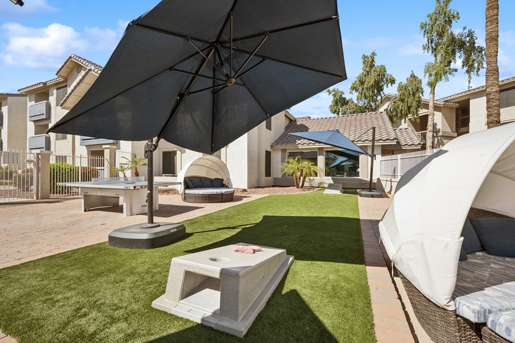 Poolside games including cornhole and ping pong