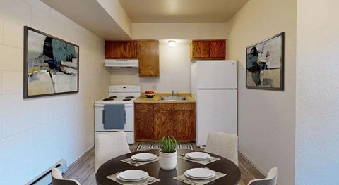 a kitchen with a dining table and a white refrigerator