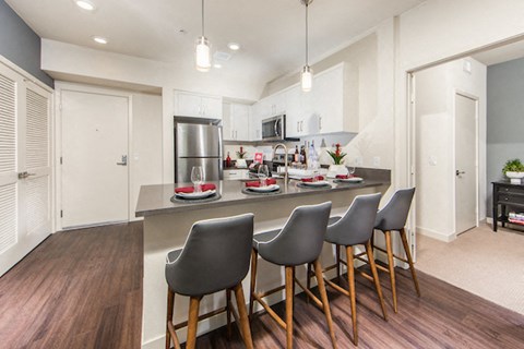 a kitchen and dining area with a counter and chairs