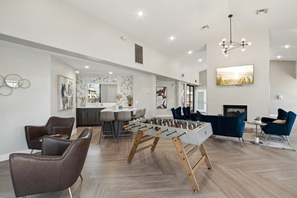 A modern living room with a fireplace and a dining table.