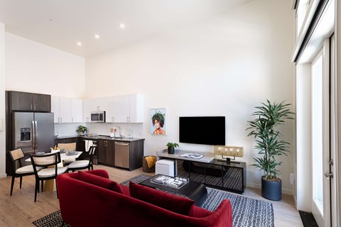 A modern living room with a red couch and a television.