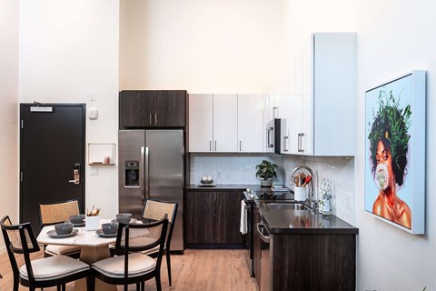 a kitchen and dining area with a table and chairs
