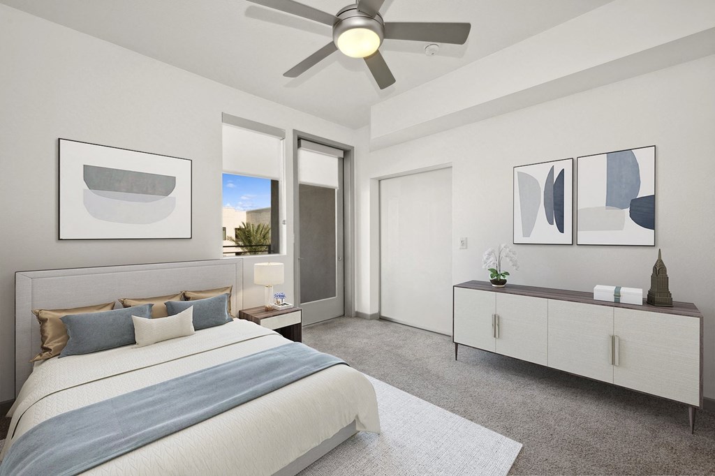 a bedroom with a large bed and a ceiling fan