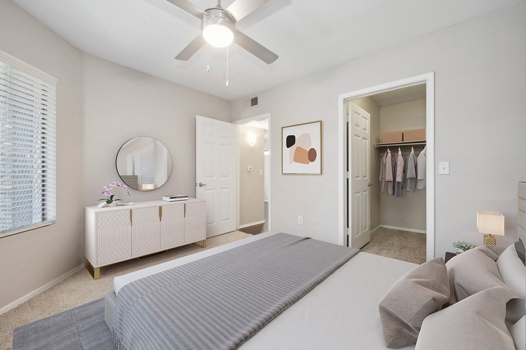 a bedroom with a large bed and a ceiling fan