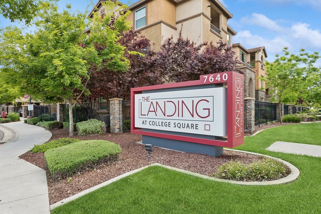 the landing at college square sign in front of a building