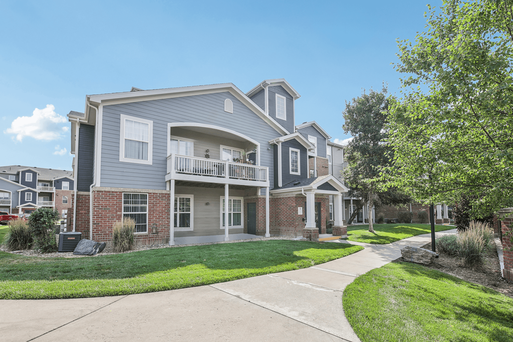 A two-story house with a balcony on the second floor.